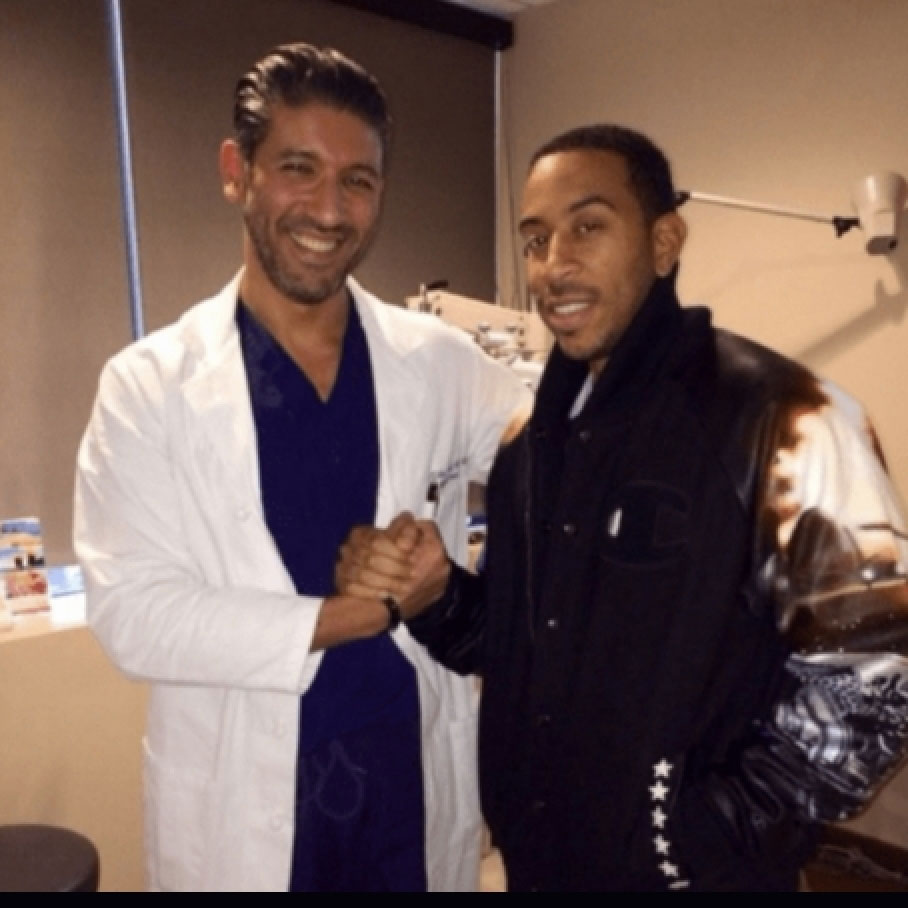 Dr. Soroudi with Ludacris smiling
